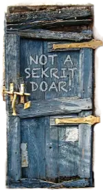 An old rickety door with peeling blue paint and rusty hinges. Someone, or some thing, has scrawled a message on it that reads, "NOT A SEKRIT DOAR!"
